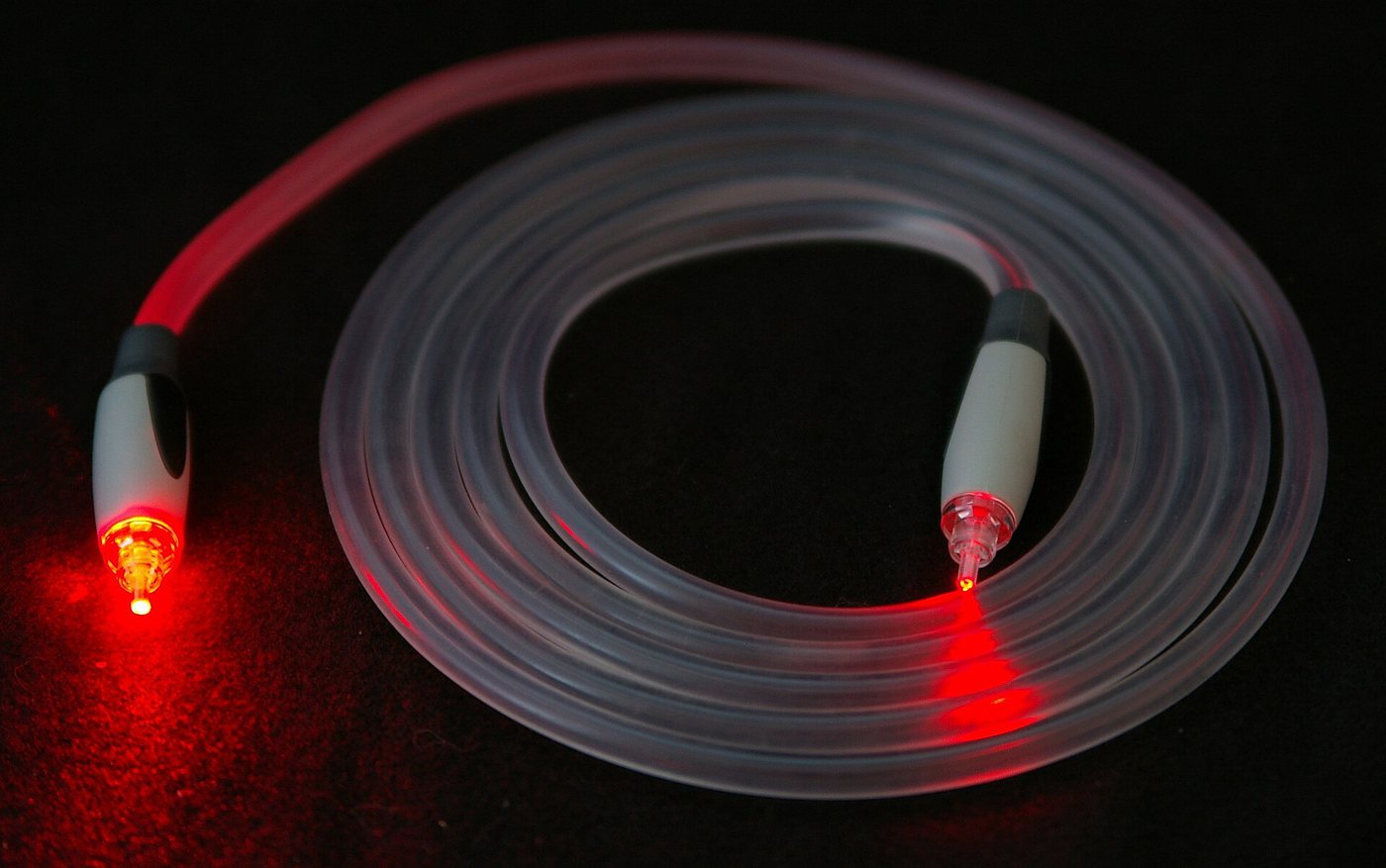 Bundle of fibre optic strands glowing at the tips