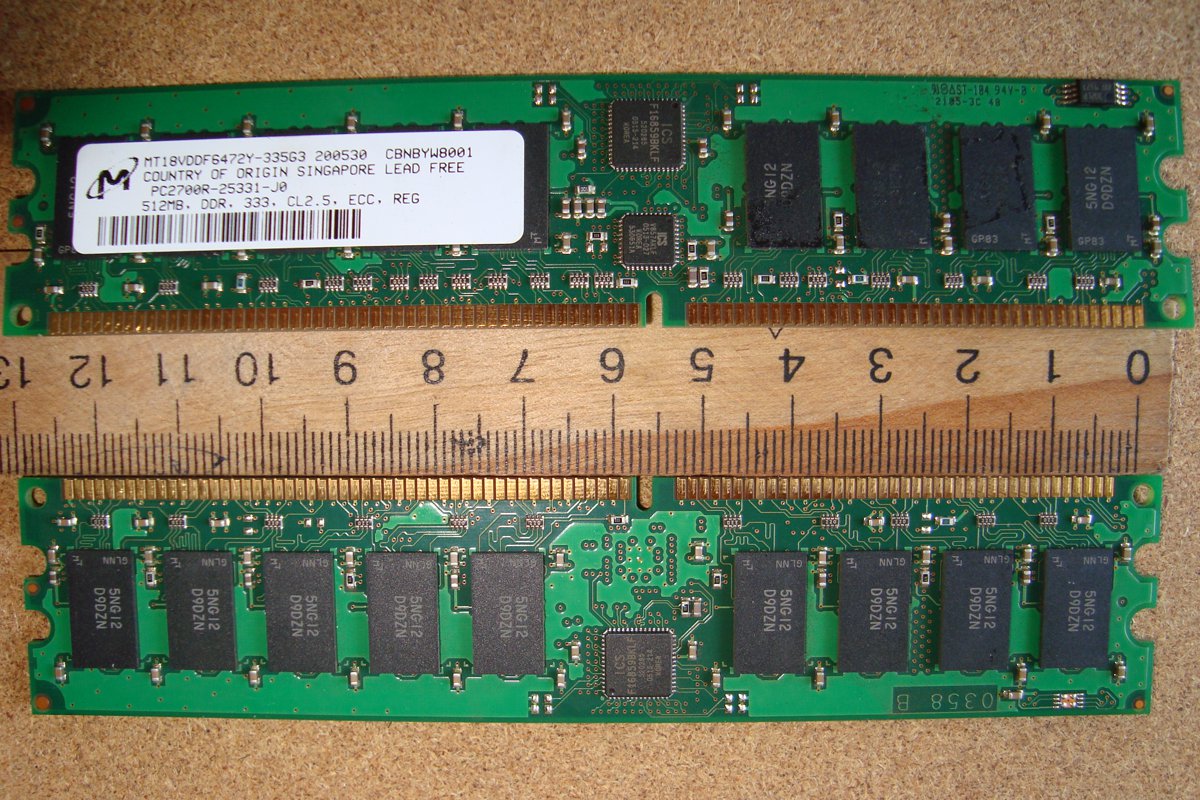 A Micron DDR memory module next to a ruler, showing the memory chips on the board
