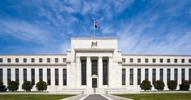 The Marriner S. Eccles Federal Reserve Board Building in Washington, DC under a blue sky